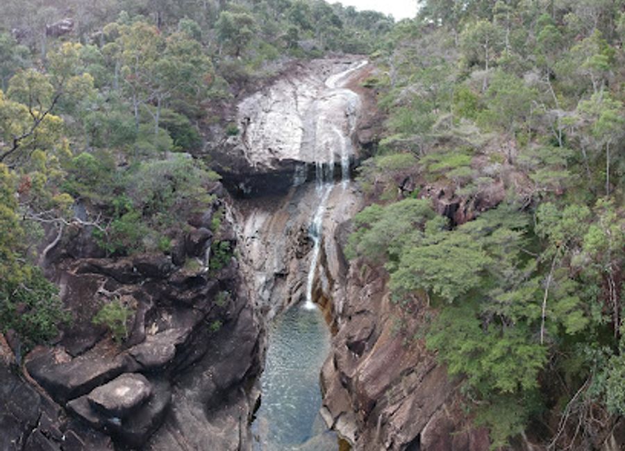 Discover the serene beauty of Mulligan Falls on Hinchinbrook Island, a perfect reward after a trek through the Thorsborne Trail's wilderness.