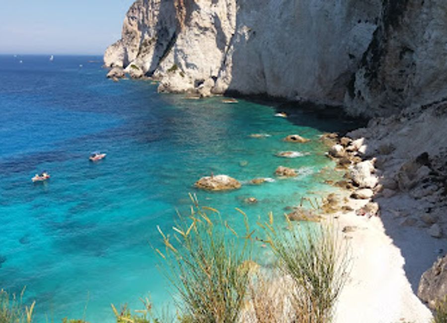 Erimitis Bay in Paxi, Greece: A picturesque tourist attraction with crystal-clear waters, stunning landscapes, and a tranquil atmosphere perfect for relaxation and adventure.