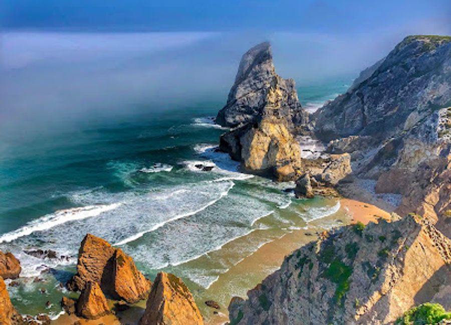 Experience the untouched beauty of Praia da Ursa, a serene beach in Portugal's Sintra-Cascais Natural Park, where cliffs meet crystal waters.