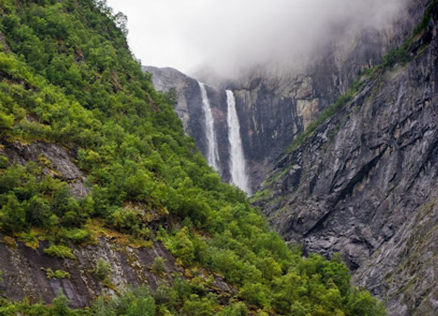 Experience the breathtaking beauty of Vedalsfossen Waterfall in Eidfjord, Norway - a must-see natural wonder amidst stunning landscapes.