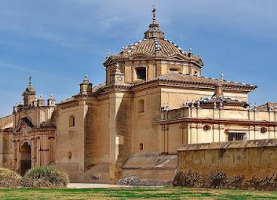 Explore the serene beauty and rich history of the Monastery of Santa Maria de las Cuevas in Seville, a cultural gem along the Guadalquivir River.