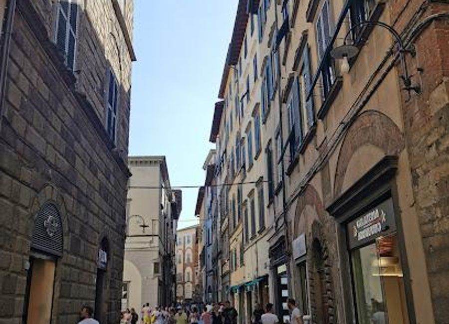 Explore the charm of Lucca on Via Fillungo, a vibrant street filled with shops, cafes, and rich history in Tuscany, Italy.