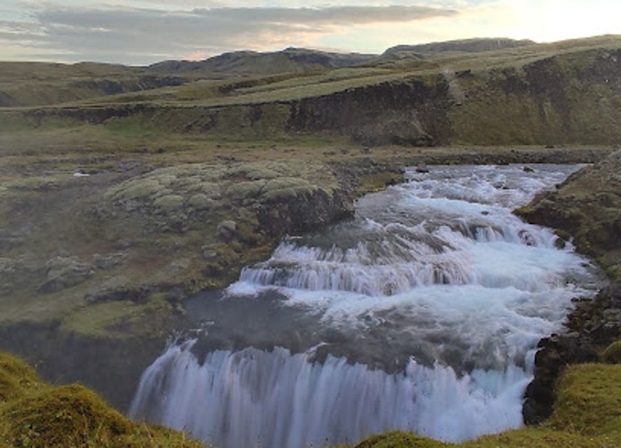 Experience the breathtaking beauty of Huldufoss Waterfall, an enchanting natural wonder in Iceland surrounded by stunning landscapes.