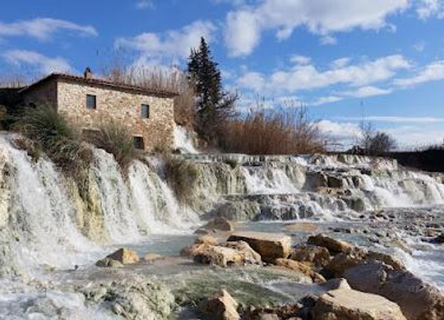 Discover the rejuvenating beauty of Cascate del Mulino, a natural thermal spring in Tuscany known for its stunning waterfalls and tranquil atmosphere.