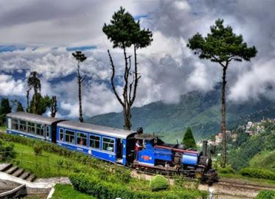 Experience a nostalgic ride on the Darjeeling Himalayan Railway, a UNESCO World Heritage Site offering breathtaking Himalayan views and a journey through history.