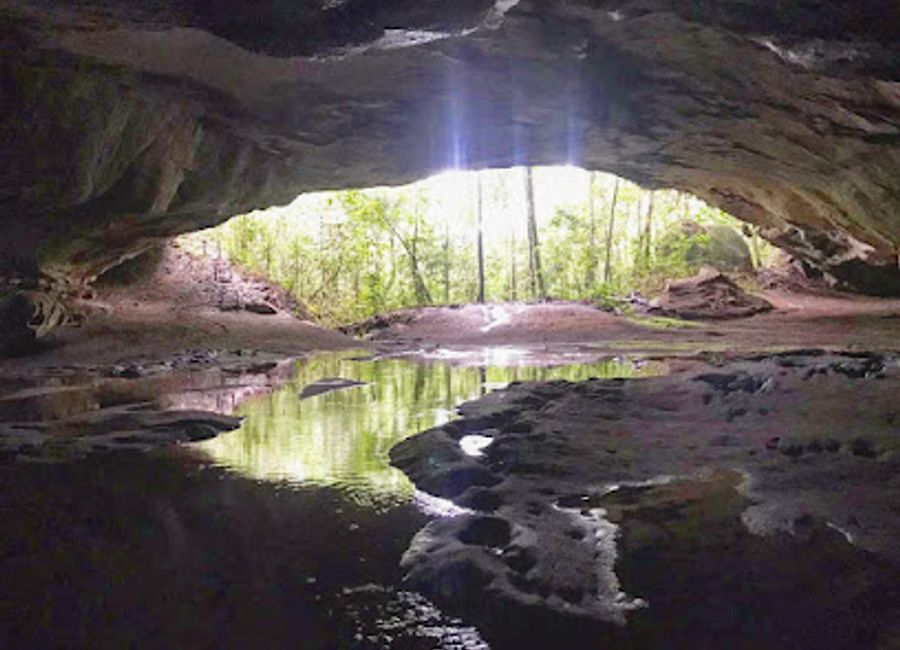 Explore Brazil's largest sandstone cave, Caverna Aroe Jari, with its stunning rock formations, waterfalls, and the mesmerizing Blue Lagoon.