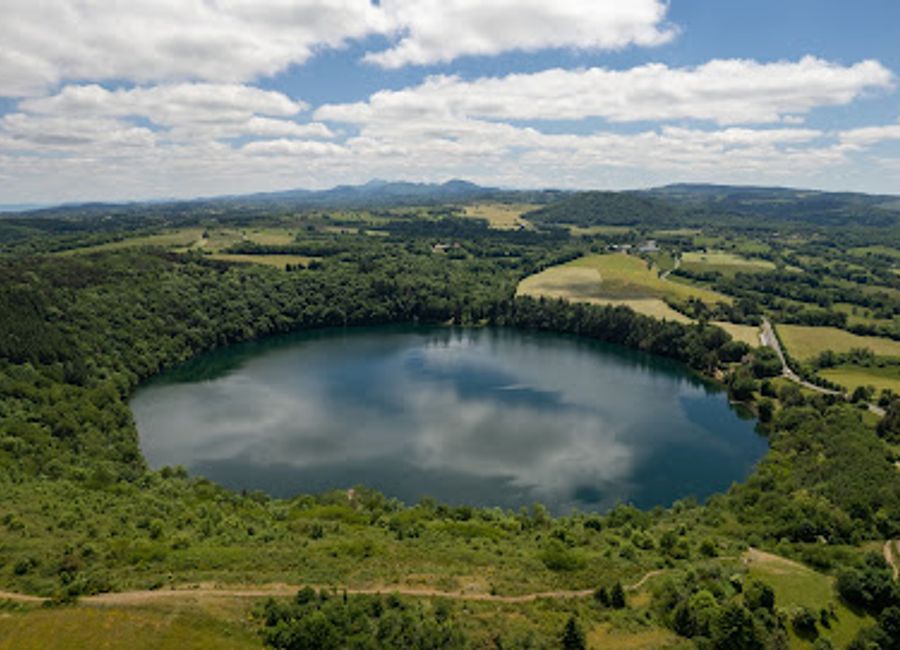 Discover the serene beauty of Gour de Tazenat, a volcanic lake in Auvergne, offering hiking, fishing, and breathtaking views in a tranquil natural setting steeped in local legends.