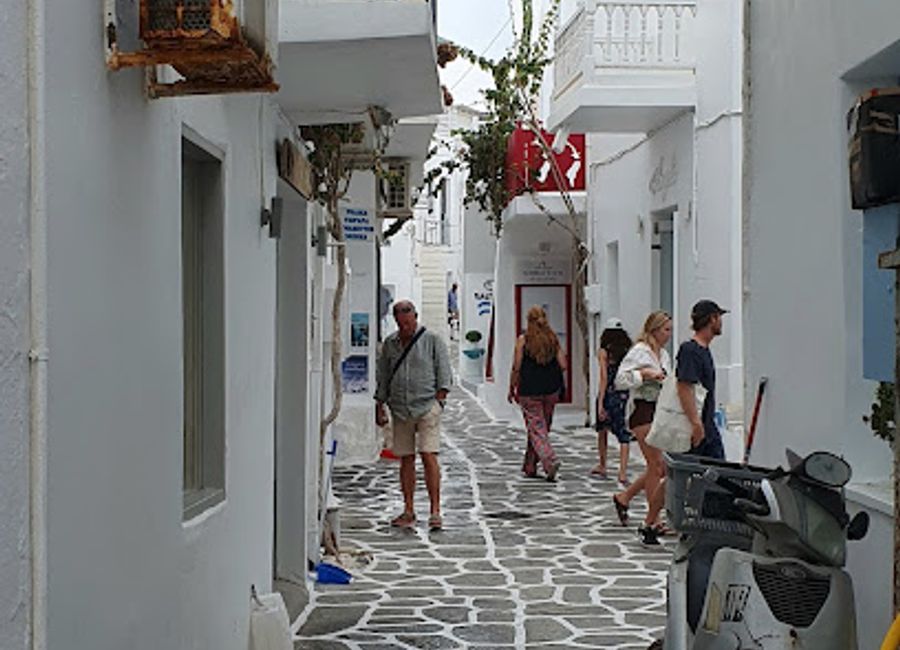 Explore the enchanting path to Faneromeni Church in Naousa, Paros, where spirituality meets stunning Aegean vistas in a serene atmosphere.
