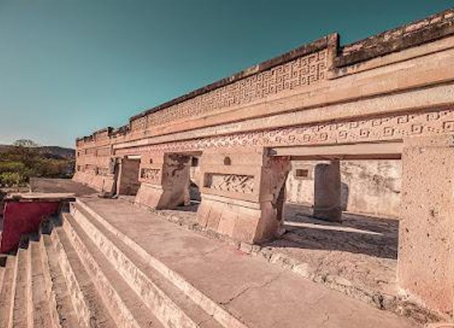 Explore the ancient architectural marvels and vibrant culture of the Zona Arqueológica de Mitla, a UNESCO World Heritage Site in Oaxaca, Mexico.
