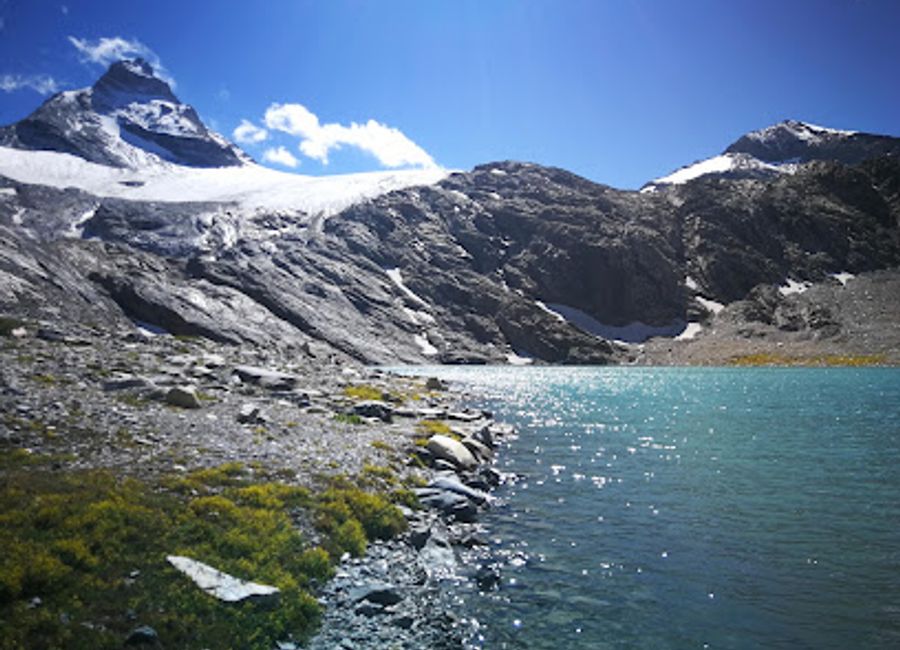 Experience the serene beauty of Lago Goletta, an alpine lake in Aosta Valley, perfect for nature lovers and adventure seekers.