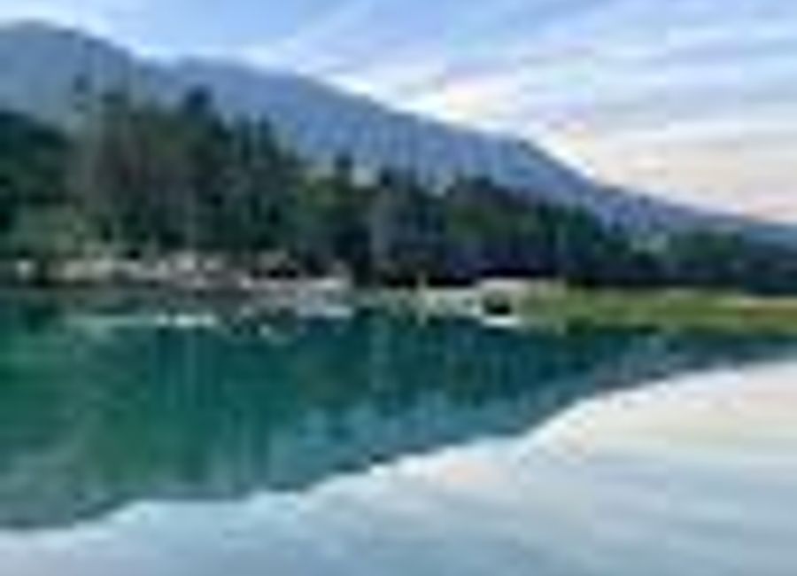 Discover the peaceful serenity of Laghetto di Pesca Sportiva Lagole, a fishing paradise surrounded by the stunning Dolomites in Italy.