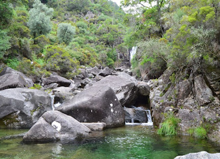 Experience the serene beauty of Cascata da Rajada, a breathtaking hiking area in Portugal, famous for its stunning waterfalls and lush landscapes.