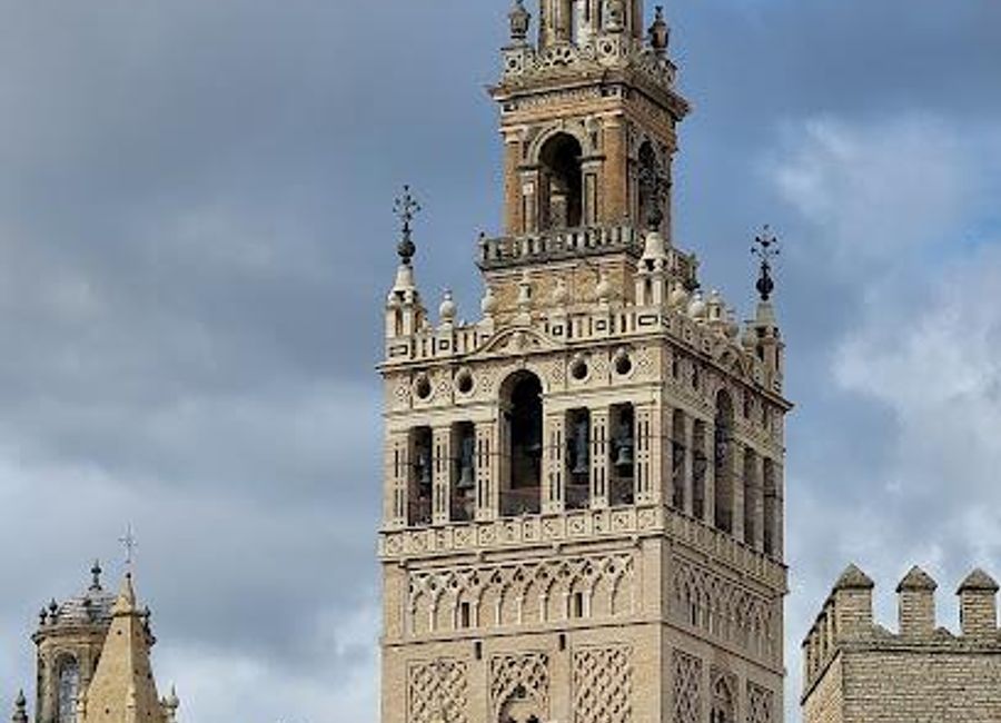 Explore La Giralda, Seville's majestic bell tower, a stunning blend of Moorish and Renaissance architecture with breathtaking views of the city.
