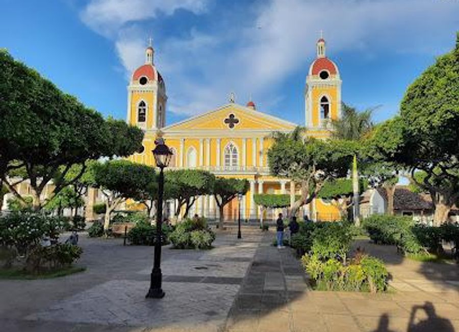 Discover the vibrant atmosphere of Parque Central in Granada, a cultural hub surrounded by colonial architecture, local eateries, and artisan markets.