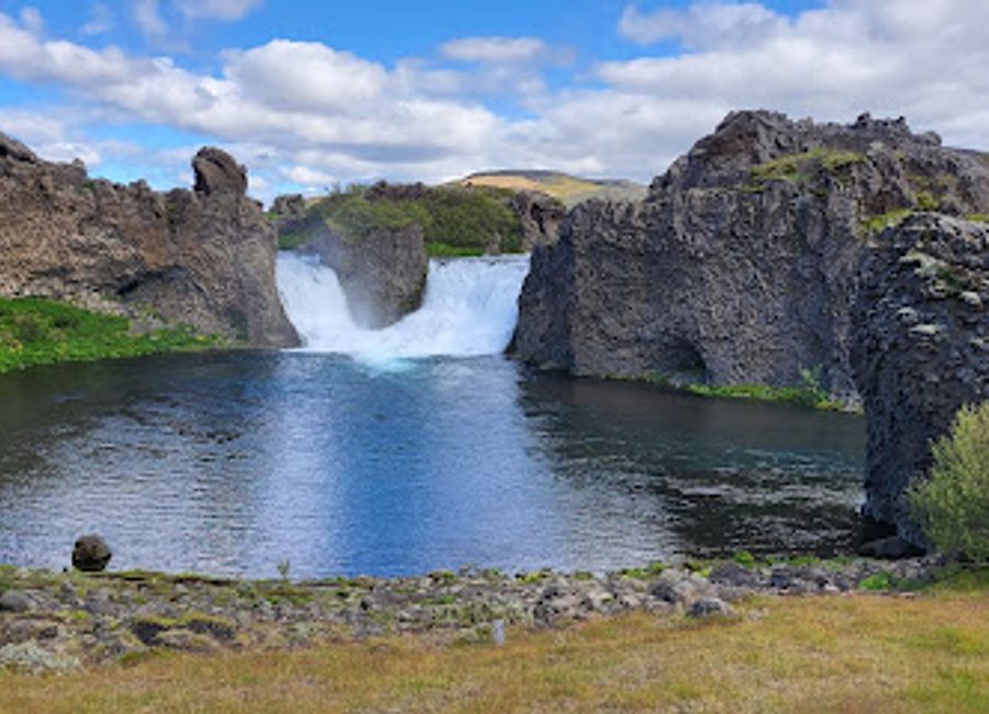 Experience the breathtaking beauty of Hjálparfoss, a stunning waterfall nestled in Iceland's Þjórsárdalur valley, perfect for nature lovers and adventurers.