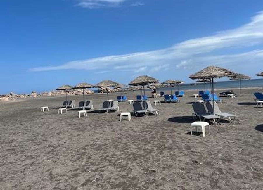 Experience the tranquil beauty of Monolithos Beach in Santorini, a hidden gem with unique black sands, crystal-clear waters, and stunning sunsets.