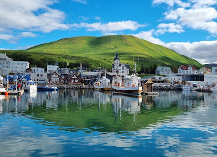 Explore the enchanting Húsavík Wooden Church, a stunning Lutheran gem surrounded by Iceland's breathtaking landscapes and rich maritime heritage.