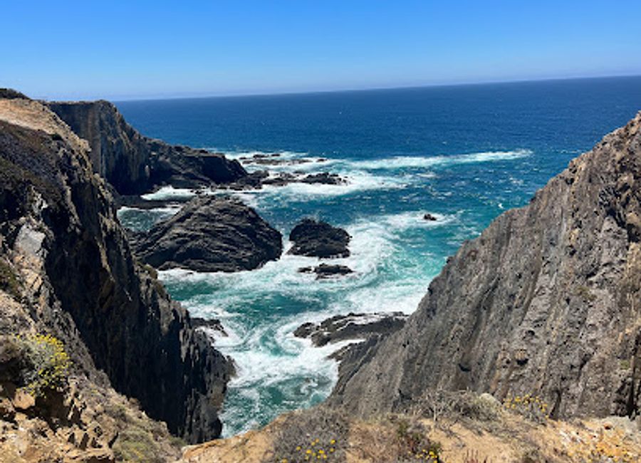 Experience the breathtaking beauty of Farol Cabo Sardão, where the cliffs meet the Atlantic Ocean in stunning harmony.