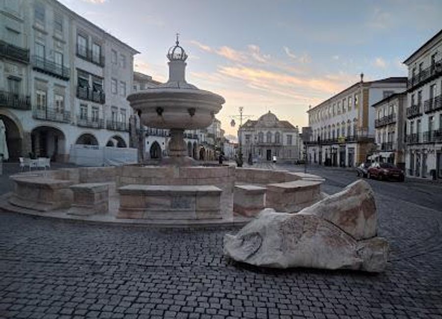 Explore the historic charm of Évora at Giraldo Square Fountain, a cultural gem surrounded by lively cafes and stunning architecture.