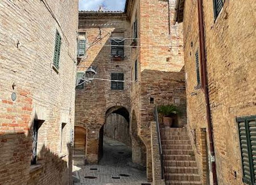 Explore the enchanting Scalinata del Pozzo della Polenta, a historical staircase in Corinaldo, Italy, offering stunning views and rich cultural experiences.