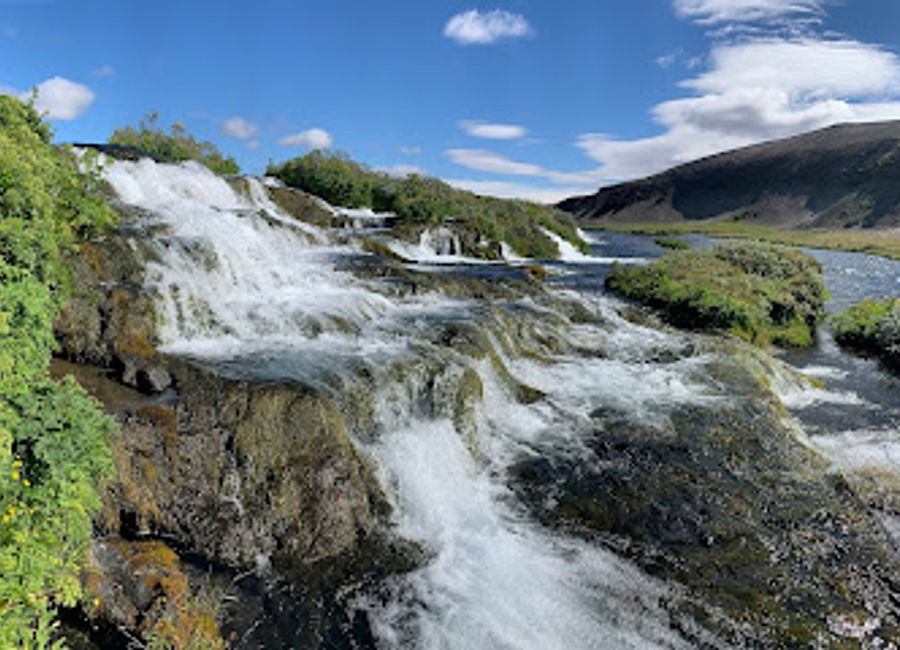 Explore the stunning waterfalls and serene landscapes of Fossabrekkur, a captivating natural attraction in the heart of Iceland.