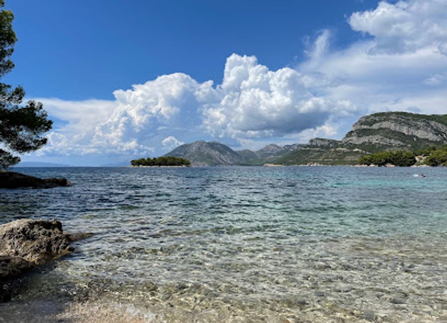 Experience the beauty and freedom of Vućine FKK Beach in Žuljana, Croatia, a perfect retreat for naturists and nature lovers alike.