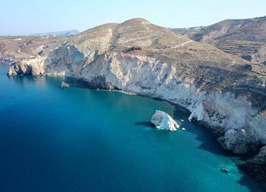 Discover the stunning beauty of White Beach in Akrotiri, Santorini, a serene escape with crystal-clear waters and unique white pebbles.