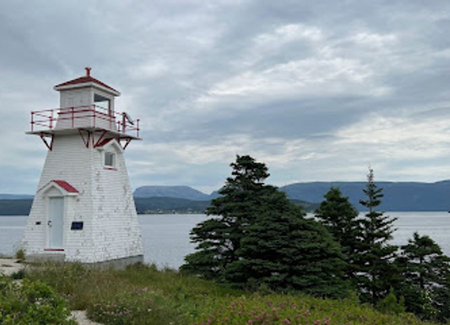 Explore the historic Woody Point Lighthouse in Newfoundland, a beacon of maritime heritage surrounded by breathtaking coastal beauty.