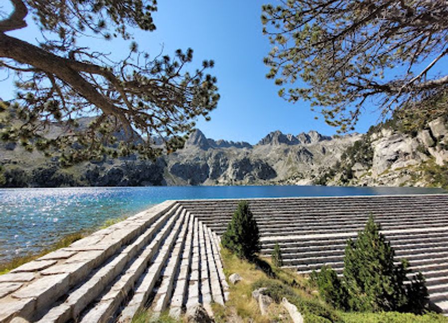 Explore the serene landscapes and breathtaking views at Presa de l'Estany Negre, a hiking paradise in Lleida, Spain.