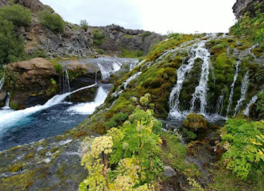 Immerse yourself in the natural beauty of Gjáin, Iceland's hidden gem with stunning waterfalls, lush greenery, and unique geological wonders.