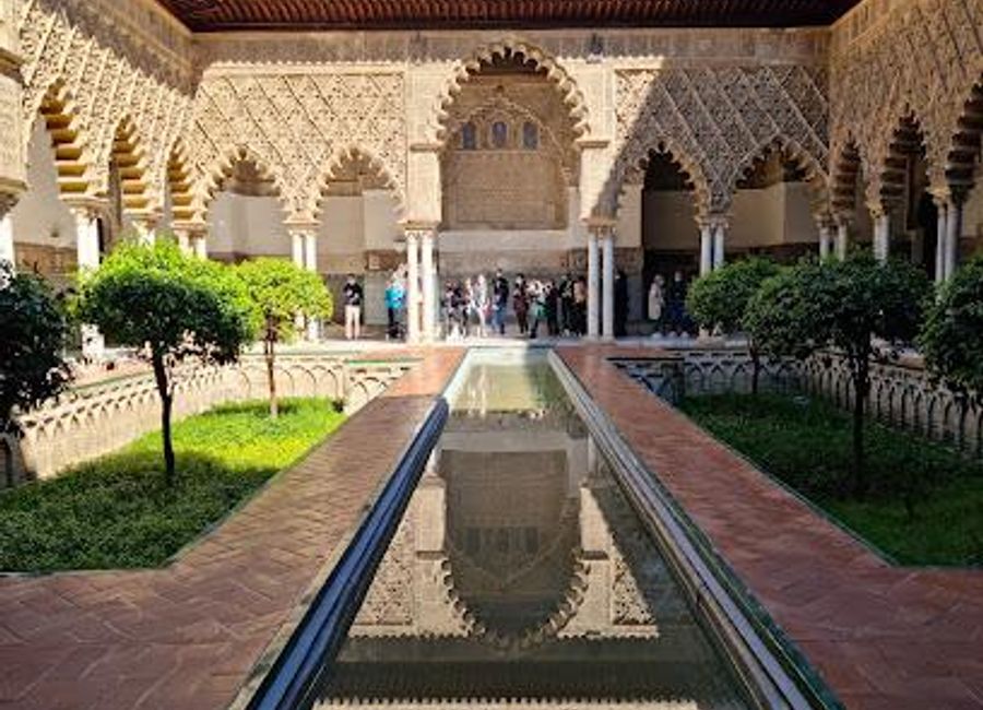 Explore the Royal Alcázar of Seville, a stunning blend of architectural styles and lush gardens, steeped in rich history and cultural significance.