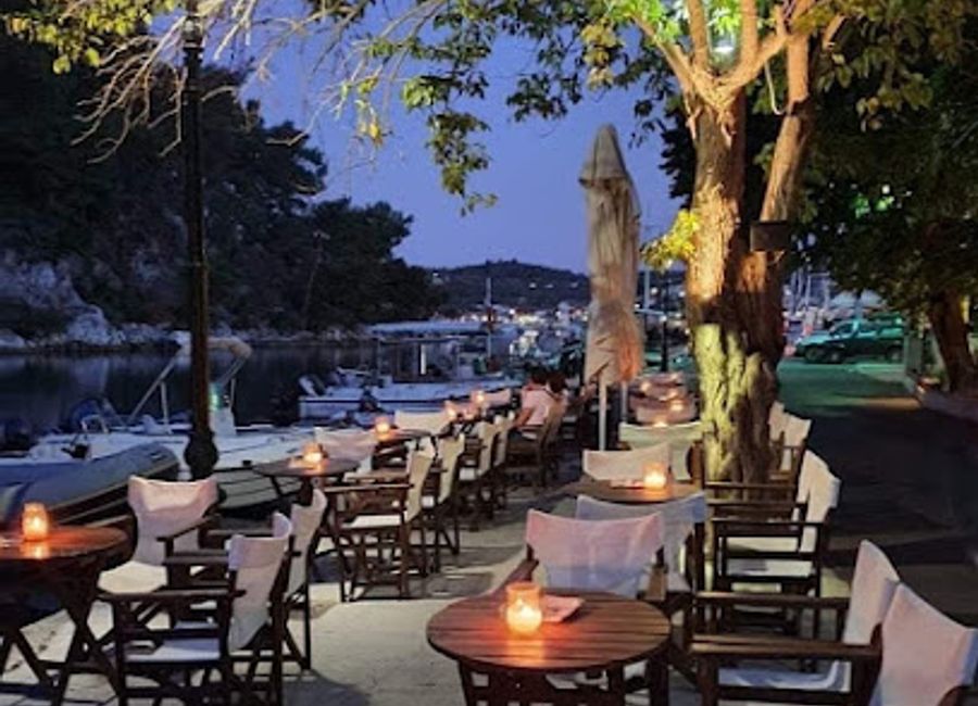 Experience the vibrant atmosphere and exquisite cocktails at Porto Vecchio in Gaios, a perfect blend of relaxation and local charm.