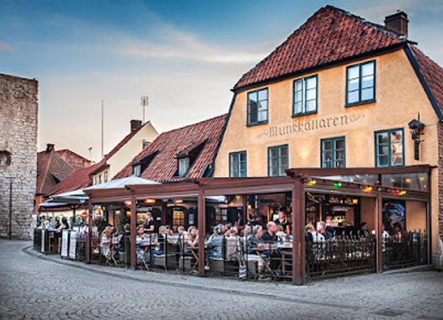 Experience the lively ambiance of Munkkällaren, where delicious cuisine meets vibrant nightlife in the heart of Visby.