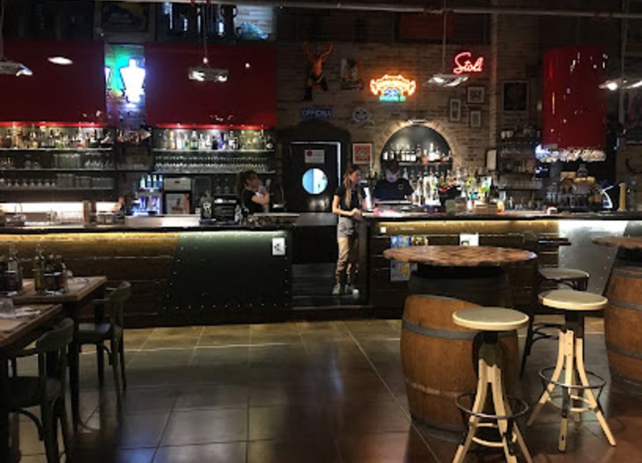 Experience the lively ambiance and delicious pizzas at Officina Gambrinus, a vibrant pub in Trento, Italy, perfect for food and nightlife lovers.