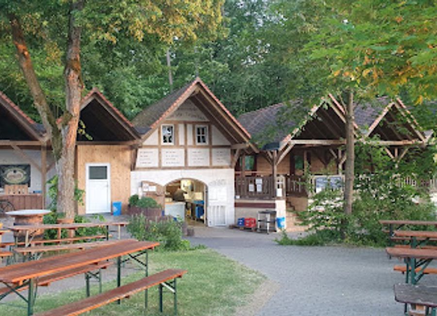 Discover the vibrant atmosphere of Schmausenkeller, a Franconian beer garden offering traditional German cuisine and local brews in a picturesque setting.