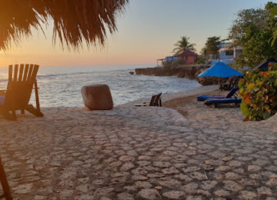 Experience laid-back vibes and authentic Caribbean flavors at Dougie's Bar in Treasure Beach, where rum punch flows and sunsets dazzle.