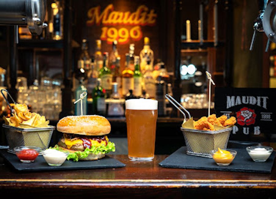 Experience the vibrant atmosphere and delicious offerings at Maudit Pub, Siena's go-to spot for craft beers and gourmet burgers.