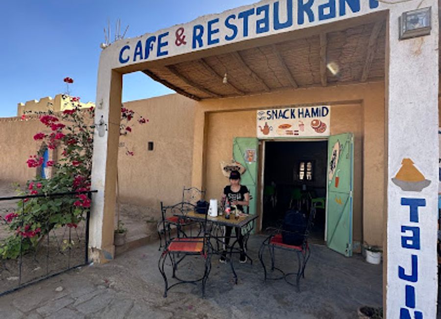 Experience authentic Moroccan cuisine and warm hospitality at Café Snack Restaurant Hamid in Merzouga, a must-visit for travelers.