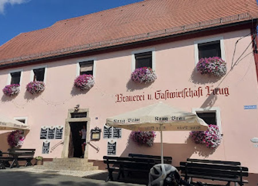 Experience authentic Bavarian culture at Krug Bräu, a brewpub offering craft beers, local cuisine, and lively dance hall entertainment in Waischenfeld.