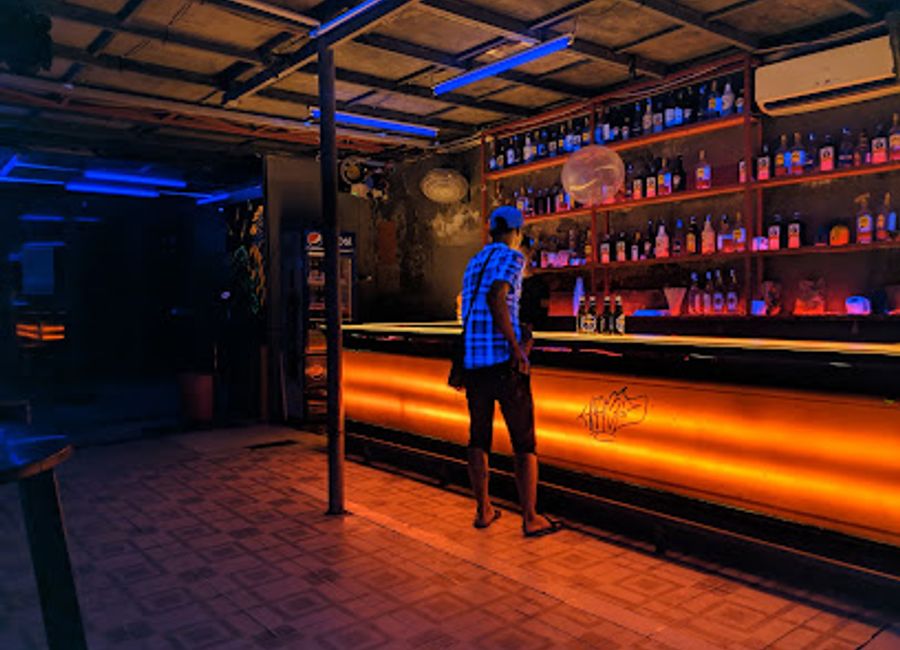 Experience vibrant nightlife and eclectic drinks at Hair Of The Dog Bar in Hội An, Vietnam, a lively spot for tourists and locals alike.