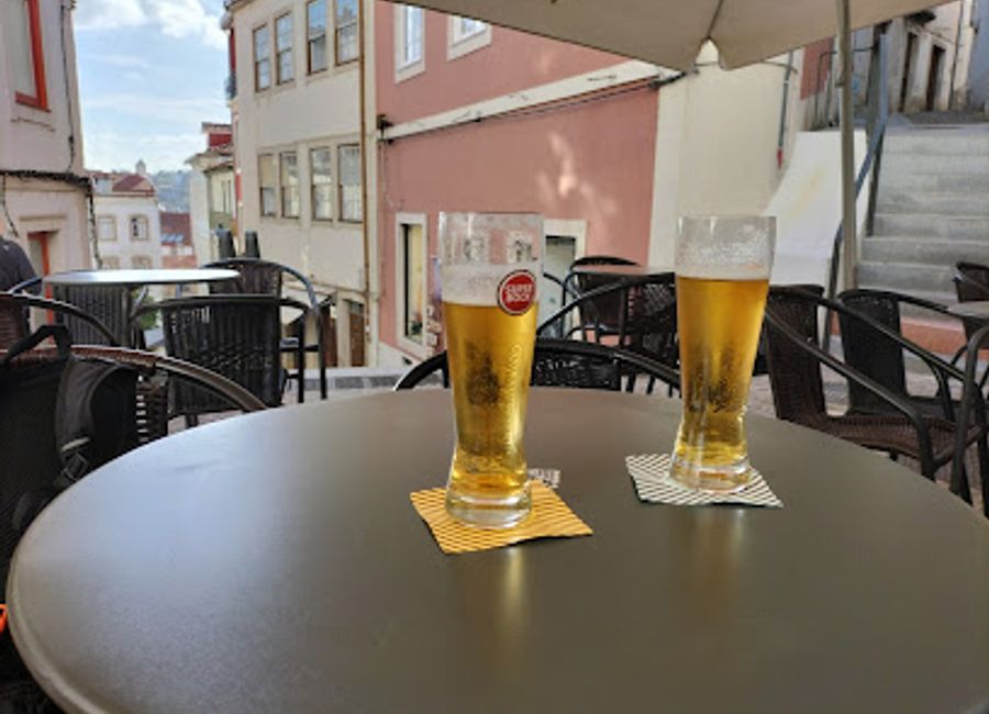 Experience the warmth and vibrancy of Coimbra at Quebra Bar, a local favorite for tasty drinks and lively atmosphere, perfect for unwinding after a day of exploration.