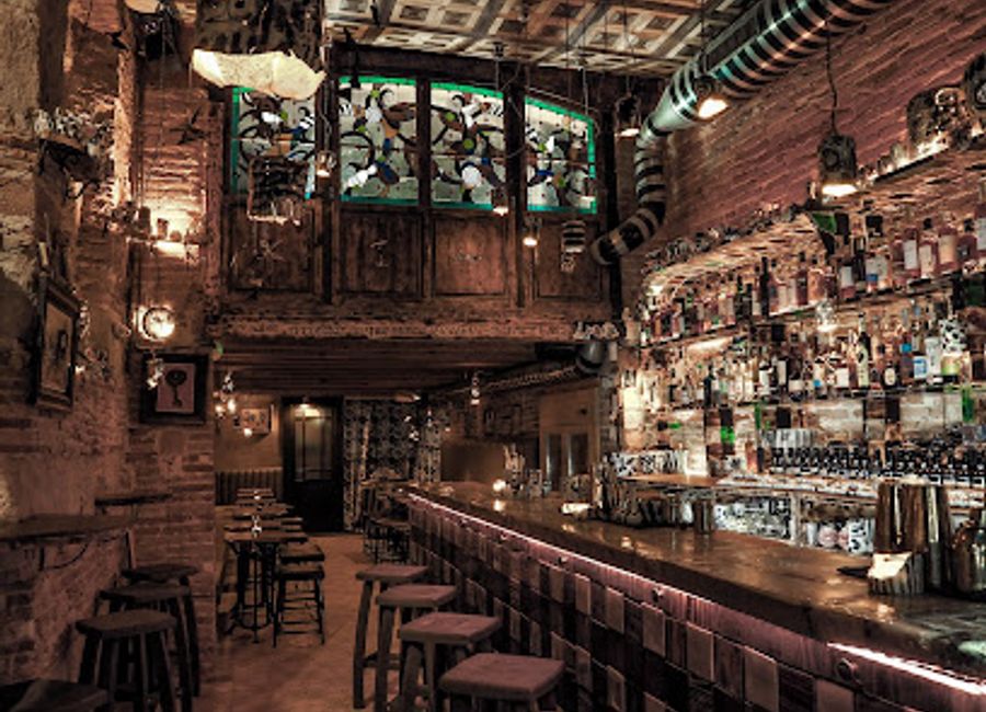 Discover unique cocktails in handmade ceramic cups at Mariposa Negra Cocktail Bar, a vibrant escape in the heart of Barcelona's Ciutat Vella.