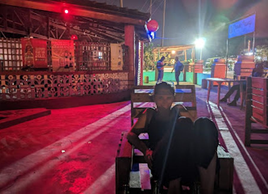 Experience the vibrant atmosphere of The Boom Pub in Elmina, Ghana, a perfect spot for relaxation and local culture.