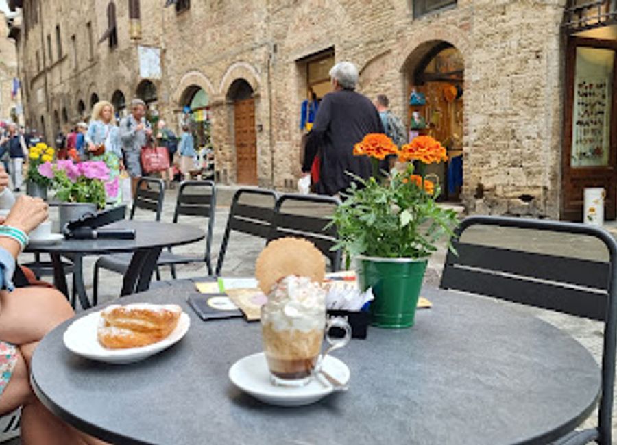 Discover the charm of Bar Firenze in San Gimignano, where authentic Italian coffee and delightful pastries await in a warm, inviting atmosphere.