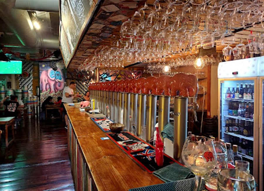 Discover the vibrant Delirium Café in Lisbon, where beer lovers rejoice in a lively atmosphere filled with delicious food and great company.