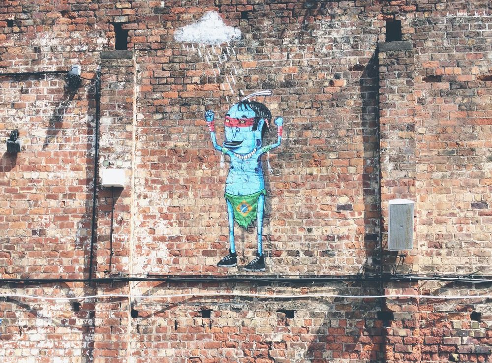 File:Cartoon art piece on brick wall (Unsplash).jpg - Wikimedia Commons