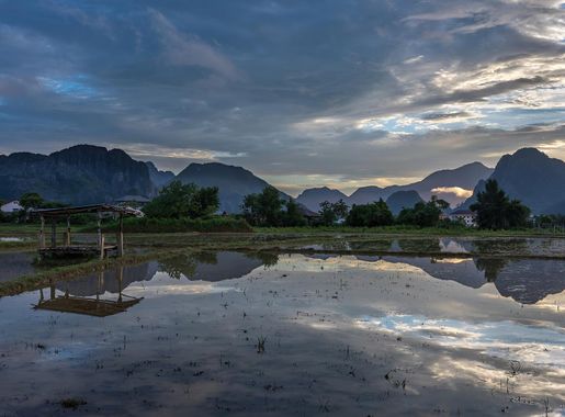 File:Water reflection of a landscape with colorful sky and karst mountains  in a paddy field at sunset Vang Vieng Laos.jpg - Wikimedia Commons