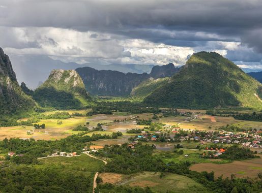 File:Karst peaks and green paddy fields under a stormy sky, South view from  Mount Nam Xay, Vang Vieng, Laos.jpg - Wikimedia Commons