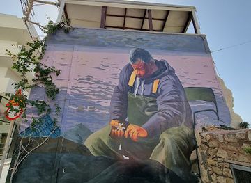 greece/heraklion/landmark/man-with-daisy-flower-street-art