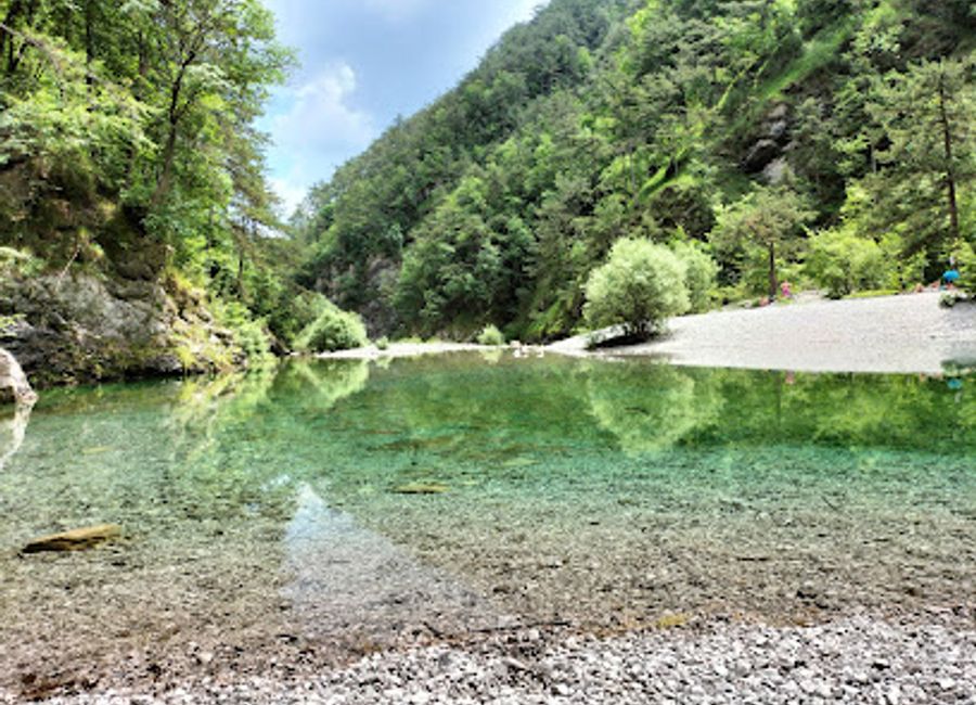Explore Pozze Smeraldine: Italy's Hidden Natural Oasis with Crystal-Clear Emerald Waters and Lush Surroundings.